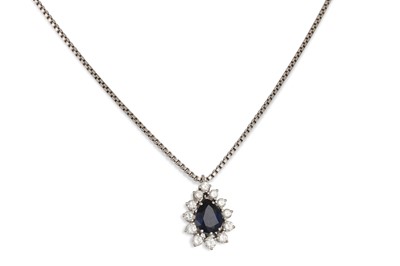 Lot 222 - A DIAMOND AND SAPPHIRE CLUSTER PENDANT, the...