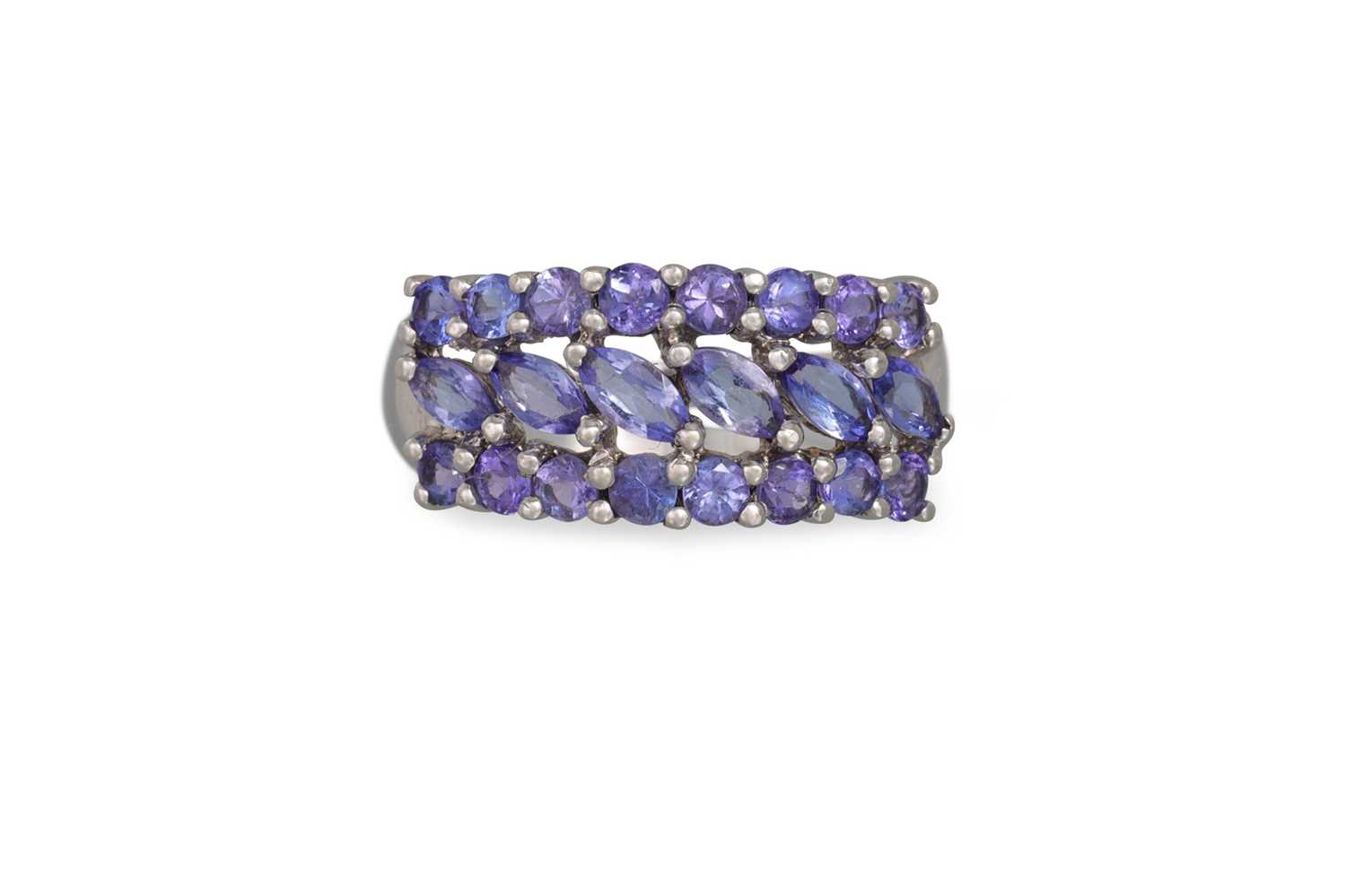 Lot 99 - A THREE ROWED TANZANITE RING, mounted in 9ct...