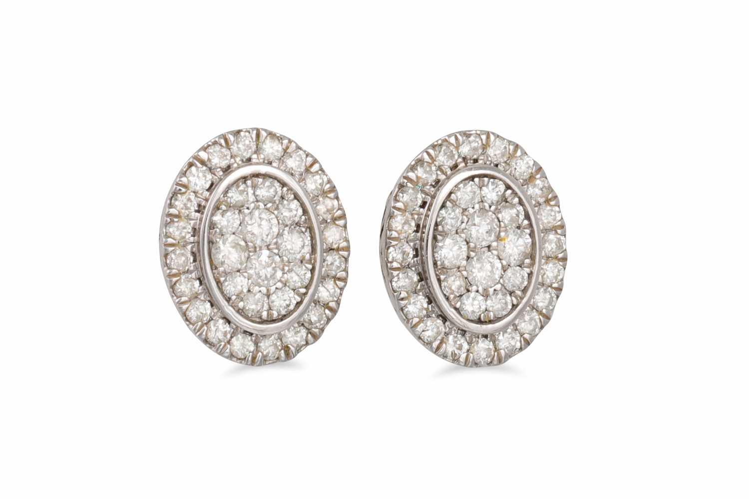 Lot 67 - A PAIR OF DIAMOND CLUSTER EARRINGS, of oval...