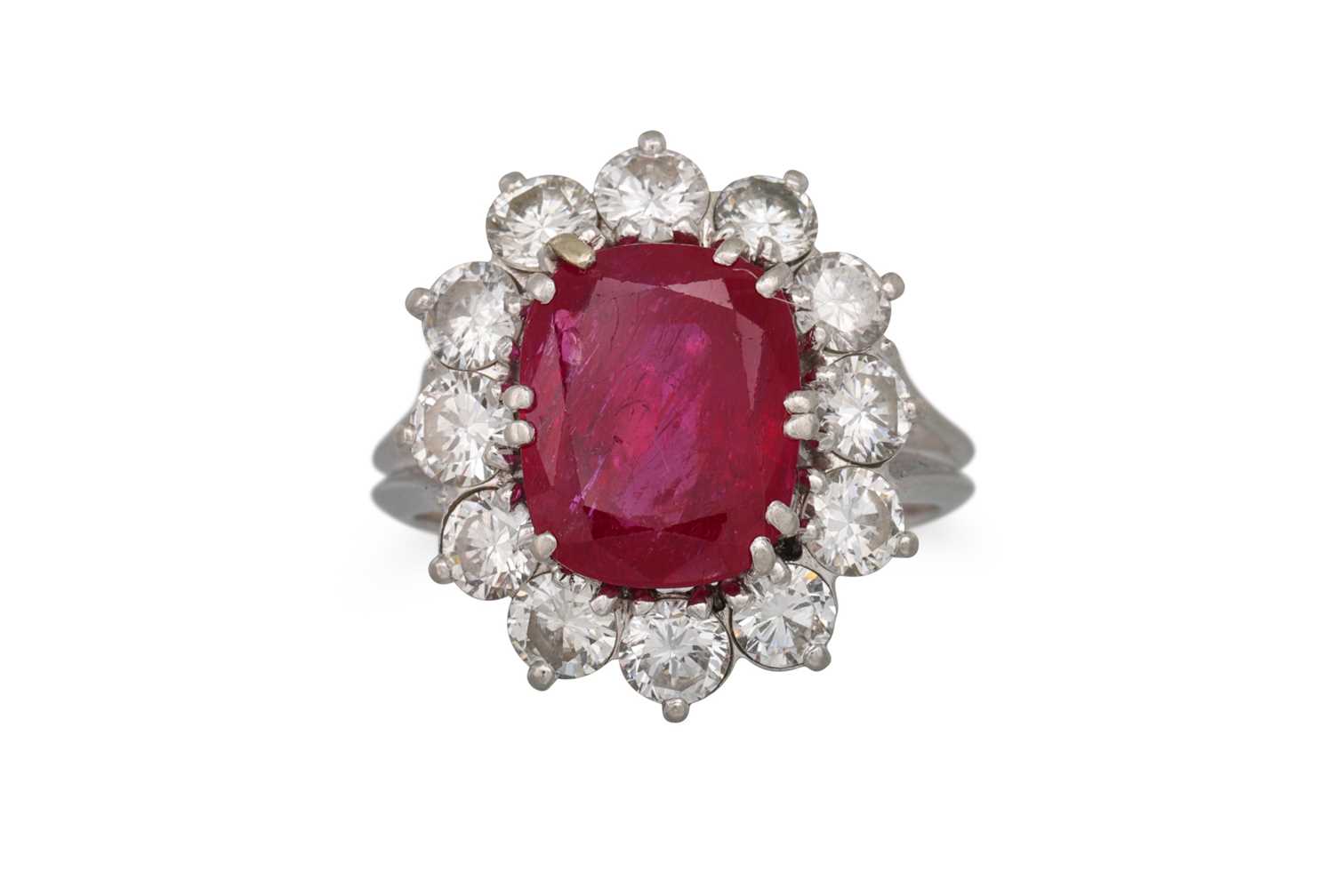 Lot 378 - A RUBY AND DIAMOND CLUSTER RING, the cushion...