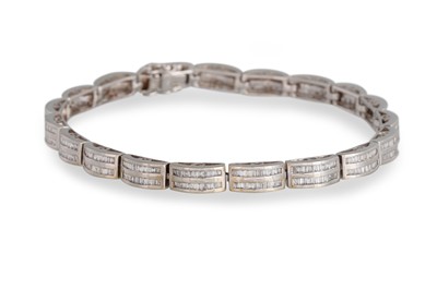 Lot 272 - A DIAMOND BRACELET, channel set with baguette...