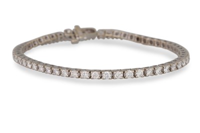 Lot 264 - A DIAMOND LINE BRACELET, the round brilliant...