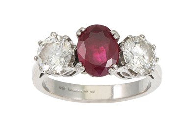 Lot 162 - A THREE STONE DIAMOND AND RUBY RING, the oval...