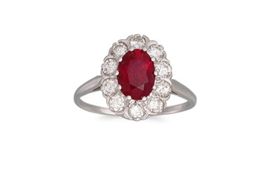 Lot 261 - A RUBY AND DIAMOND CLUSTER RING, the oval ruby...