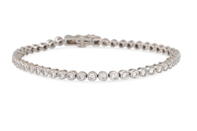 Lot 403 - A DIAMOND LINE BRACELET, the brilliant cut...