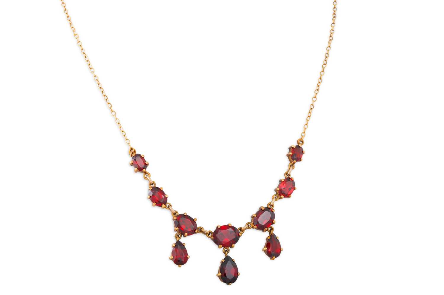 Lot 49 - A GARNET SET NECKLACE, the oval & pear shaped...