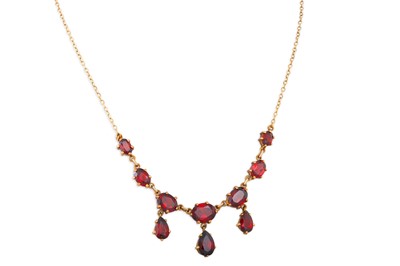 Lot 49 - A GARNET SET NECKLACE, the oval & pear shaped...