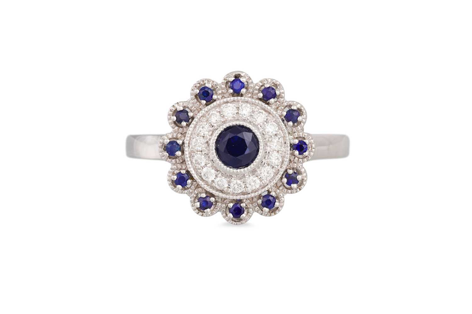 Lot 52 - A DIAMOND AND SAPPHIRE CLUSTER RING, the round...