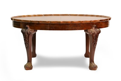 Lot 213 - AN OVAL WALNUT COFFEE TABLE, wavy border...