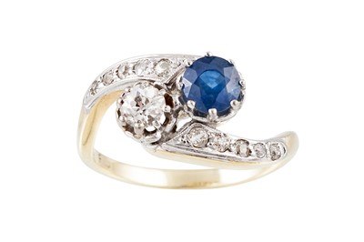 Lot 246 - A DIAMOND AND SAPPHIRE CROSS OVER RING,...