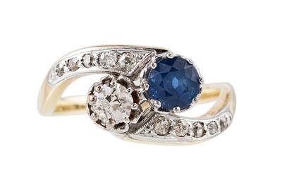 Lot 246 - A DIAMOND AND SAPPHIRE CROSS OVER RING,...