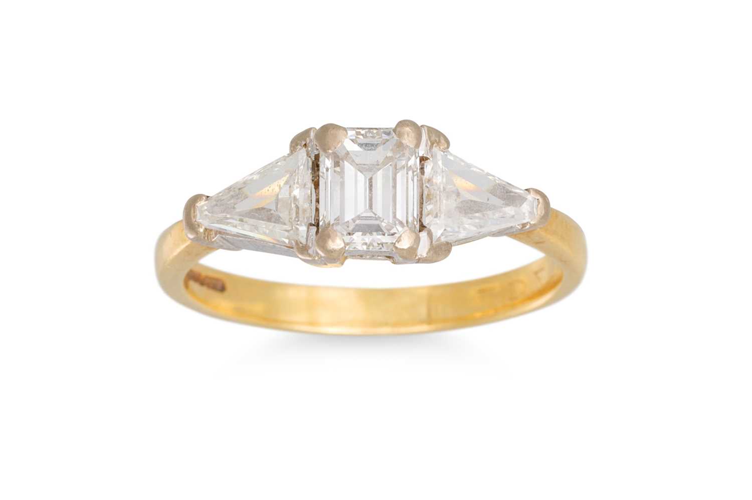 Lot 66 - AN EMERALD CUT DIAMOND RING, with trillion...