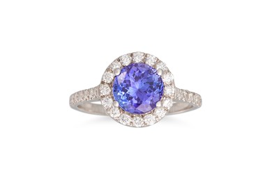 Lot 273 - A TANZANITE AND DIAMOND RING, the circular...