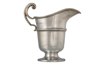 Lot 511 - A GEORGE V SILVER CREAM JUG, of plain helmet...