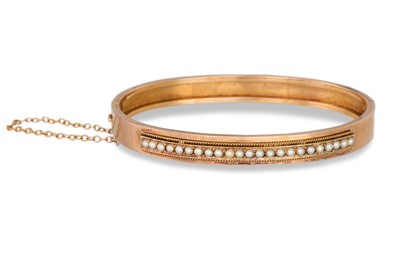 Lot 329 - AN ANTIQUE PEARL BANGLE, in yellow gold, with...