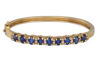 Lot 362 - A SAPPHIRE AND DIAMOND SET BANGLE, mounted in...