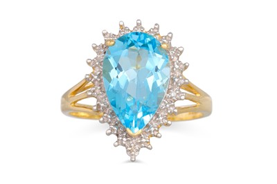 Lot 21 - A TOPAZ AND DIAMOND RING, the pear shaped...
