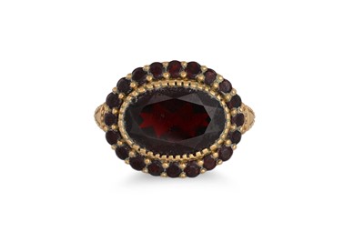 Lot 147 - A VINTAGE GARNET SET DRESS RING, mounted in...