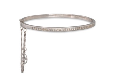 Lot 360 - A DIAMOND SET BANGLE, channel set with...