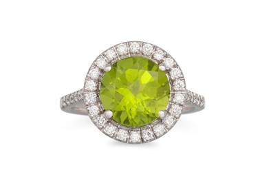 Lot 291 - A PERIDOT AND DIAMOND RING, the round peridot...