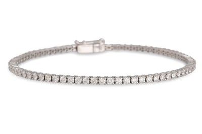 Lot 414 - A DIAMOND LINE BRACELET, the brilliant cut...