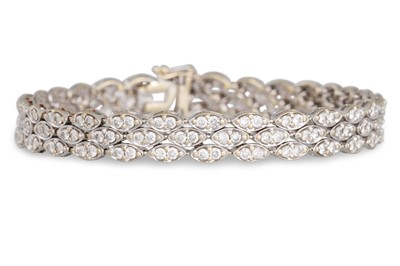 Lot 185 - A DIAMOND SET PANEL BRACELET, the oval-shaped...