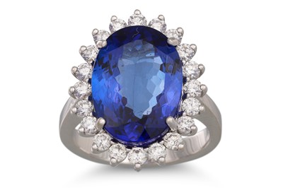 Lot 152 - A TANZANITE AND DIAMOND CLUSTER RING, the oval...