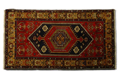 Lot 273 - A VINTAGE TURKISH YAHYALI WOOL RUG, handmade...