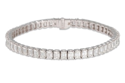 Lot 185 - AN EMERALD CUT DIAMOND LINE BRACELET, mounted...