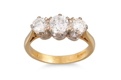 Lot 167 - A THREE STONE DIAMOND RING, the brilliant cut...