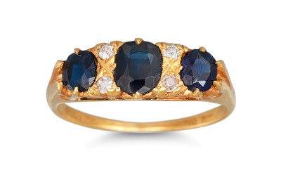 Lot 215 - A SAPPHIRE AND DIAMOND RING, the oval sapphire...