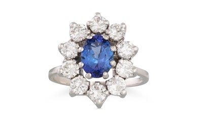 Lot 265 - A DIAMOND AND TANZANITE CLUSTER RING, the oval...