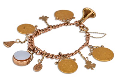 Lot 140 - A GOLD CHARM BRACELET, set with two gold full...