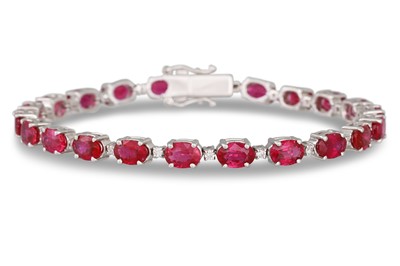 Lot 373 - A RUBY AND DIAMOND LINE BRACELET, the oval...