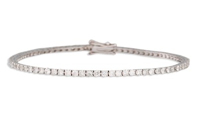 Lot 269 - A DIAMOND LINE BRACELET, the brilliant cut...