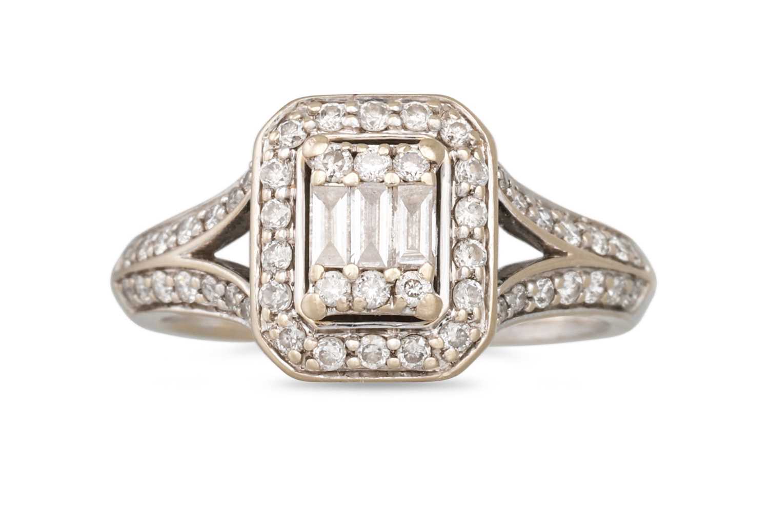 Lot 388 - A DIAMOND CLUSTER RING, three baguette cut...