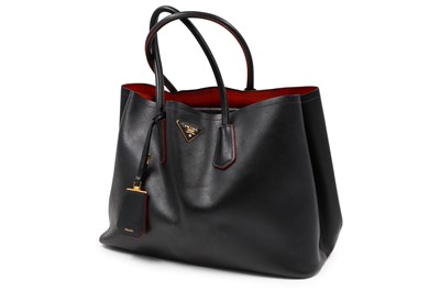 Lot 527 - A BLACK PRADA HANDBAG, double leather, red lining