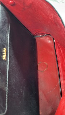 Lot 527 - A BLACK PRADA HANDBAG, double leather, red lining