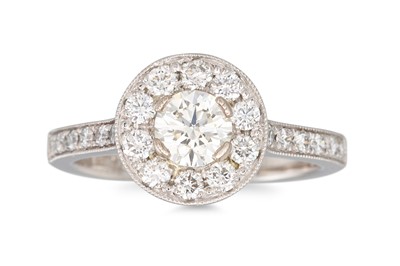 Lot 310 - A DIAMOND HALO CLUSTER RING, set with...