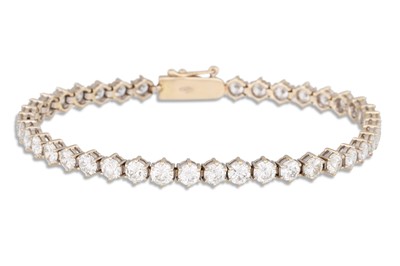 Lot 282 - A DIAMOND LINE BRACELET, the brilliant cut...